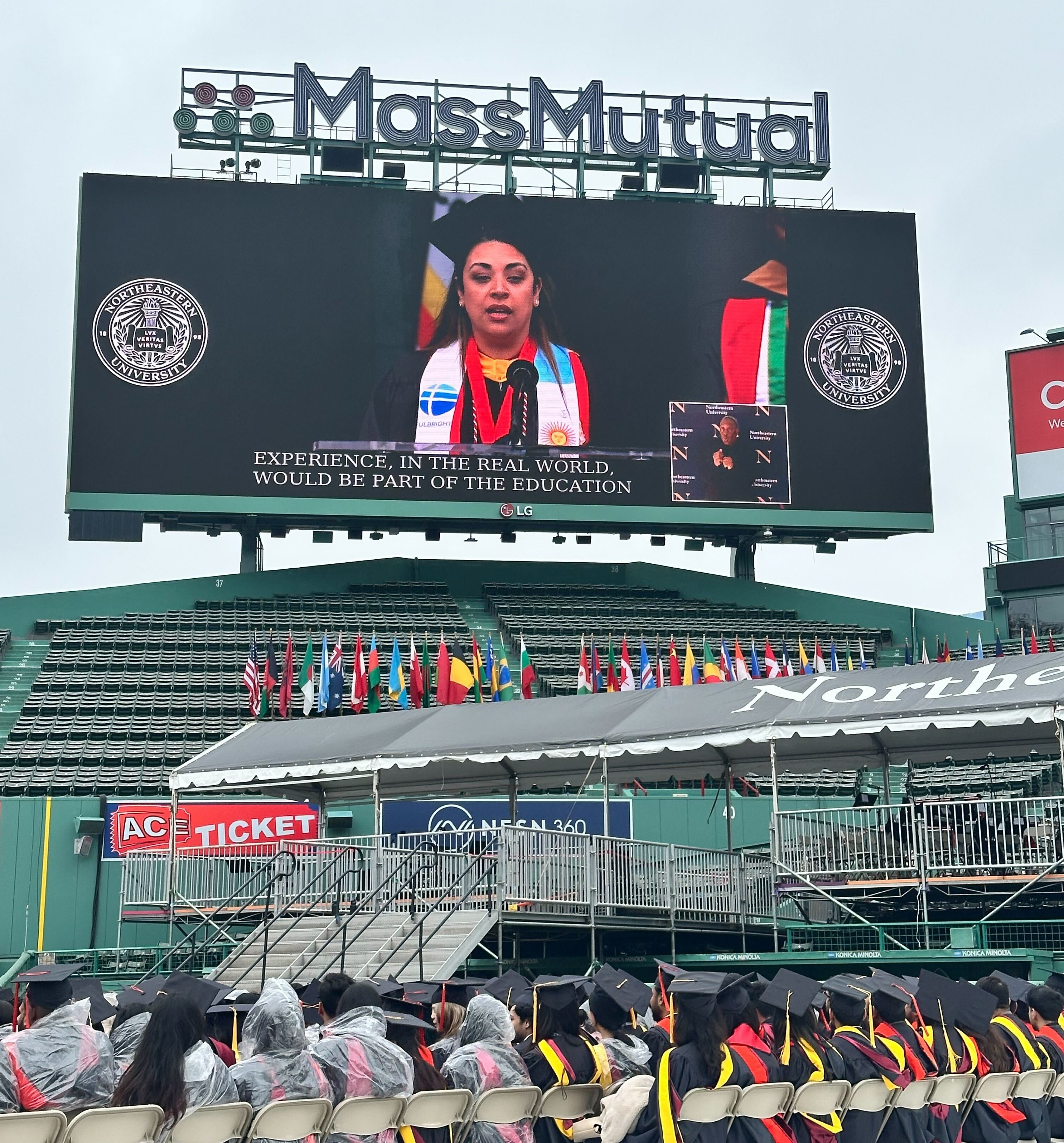 Daniela Gonzalez delivering her address on the Fenway Park scoreboard during the 2026 Boston Graduate Commencement.